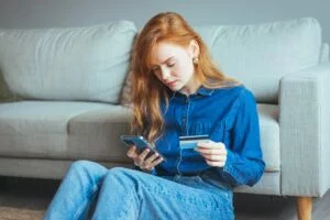 Woman checking her banking app for a direct deposit