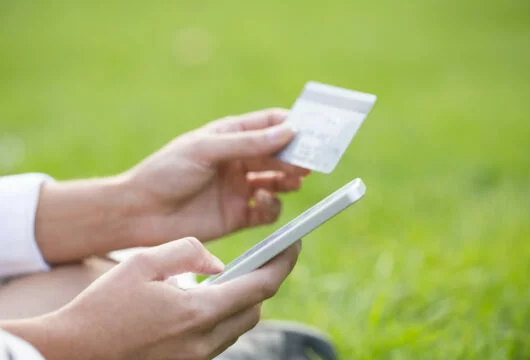 Woman checking her CSL Plasma card balance using a smartphone