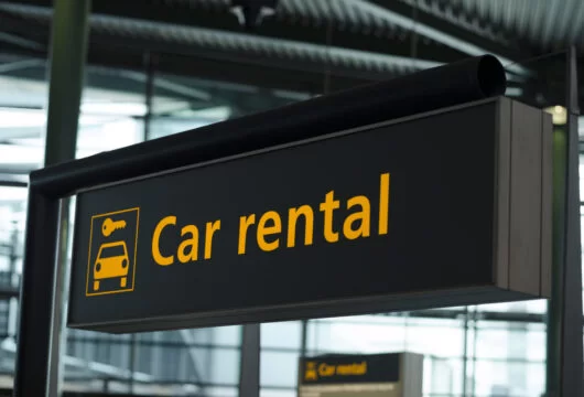 "Car rental" sign at an airport