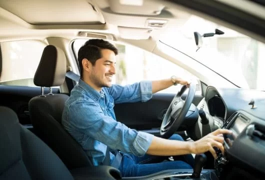 Man driving a rental car that accepts Chime credit cards