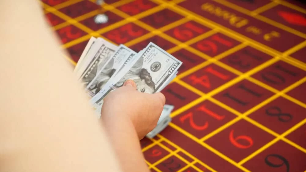 Cash at poker table after having cashed a check at the casino.