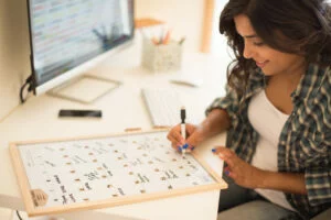 Woman marking a money order reminder on her calendar