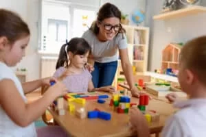 Woman teaching young children at a school like Everbrook Academy