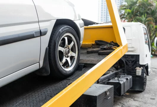 Car being loaded onto a tow truck during repossession