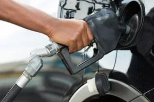 Man's hand pumping gas