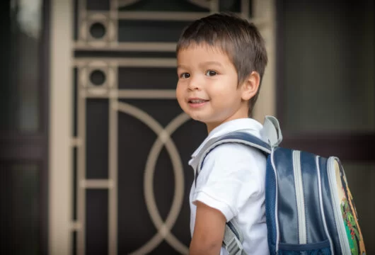 Young boy leaving home for his first day of preschool