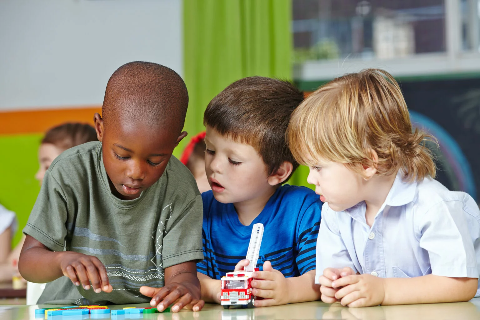 Three boys doing an educational activity at a school like Lightbridge Academy