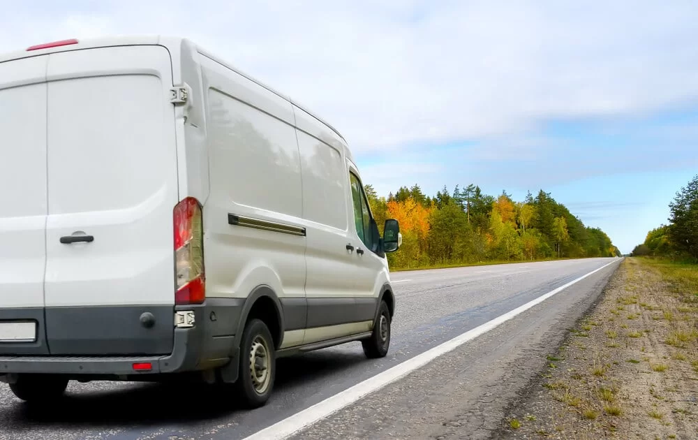 Cargo van driving on a rural highway