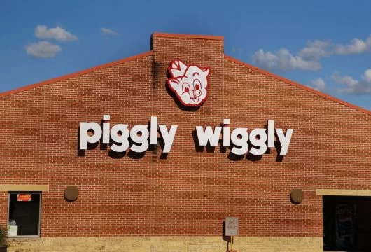 Logo sign above the front entrance of a Piggly Wiggly store