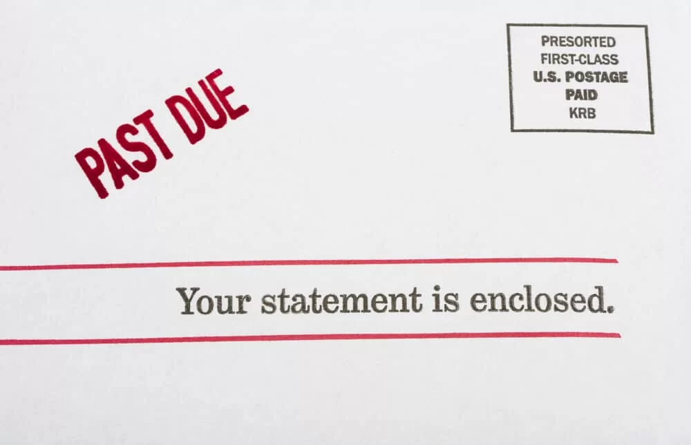 "Past Due" stamp on a statement envelope