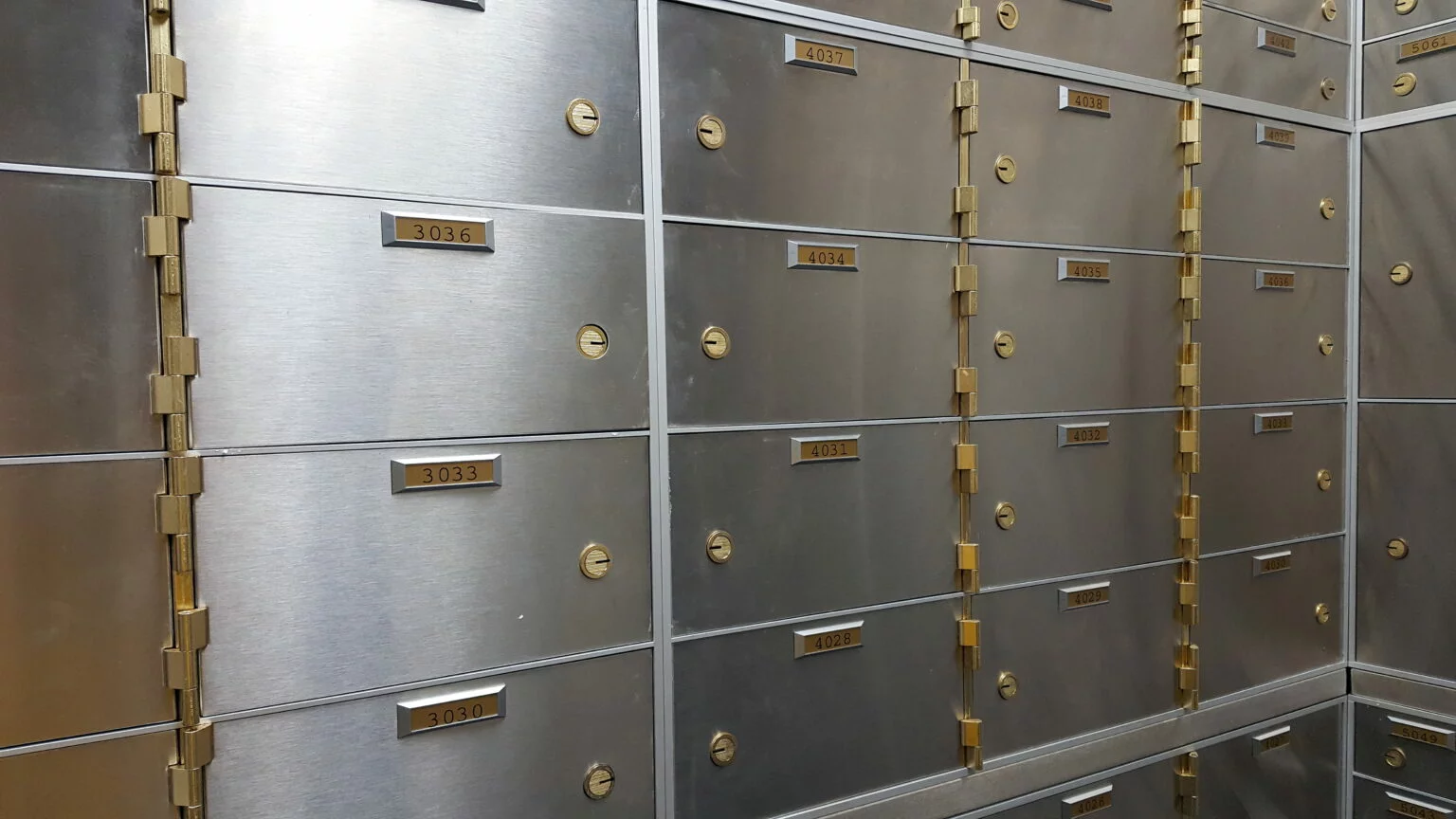 Wall of safe deposit boxes inside of a bank