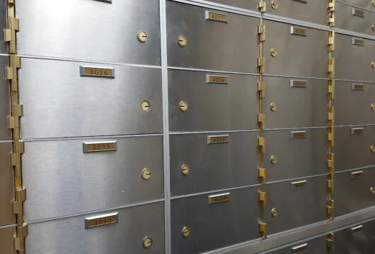 Wall of safe deposit boxes inside of a bank