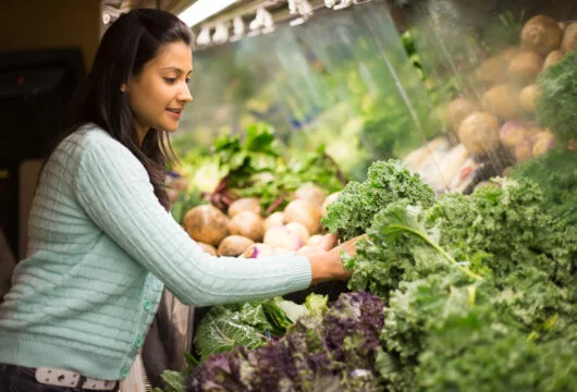 Woman grocery shopping at a store that accepts EBT