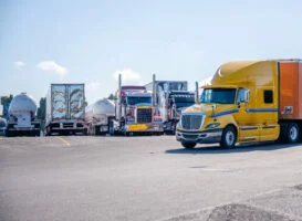 Yellow rig pulling into a truck stop parking lot to get a Comchek