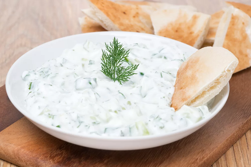 Bowl of tzatziki sauce with pita bread