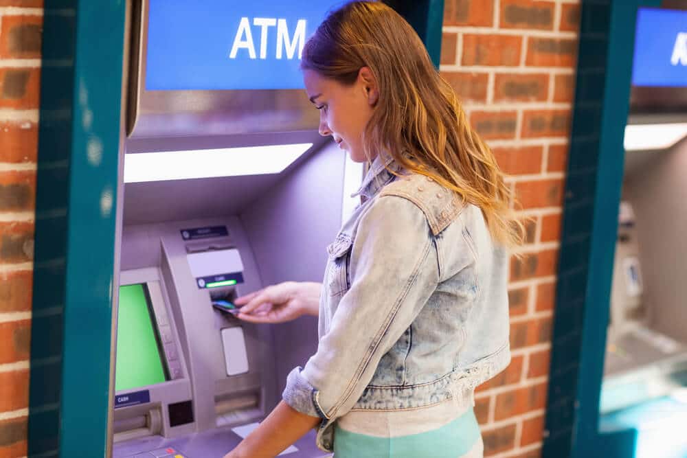 Woman withdrawing money from an ATM