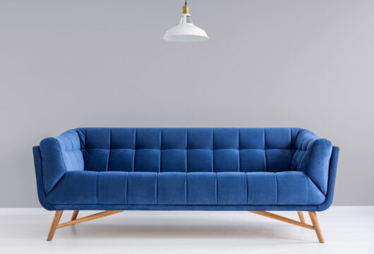 Blue rent-to-own couch from a store like Aaron's