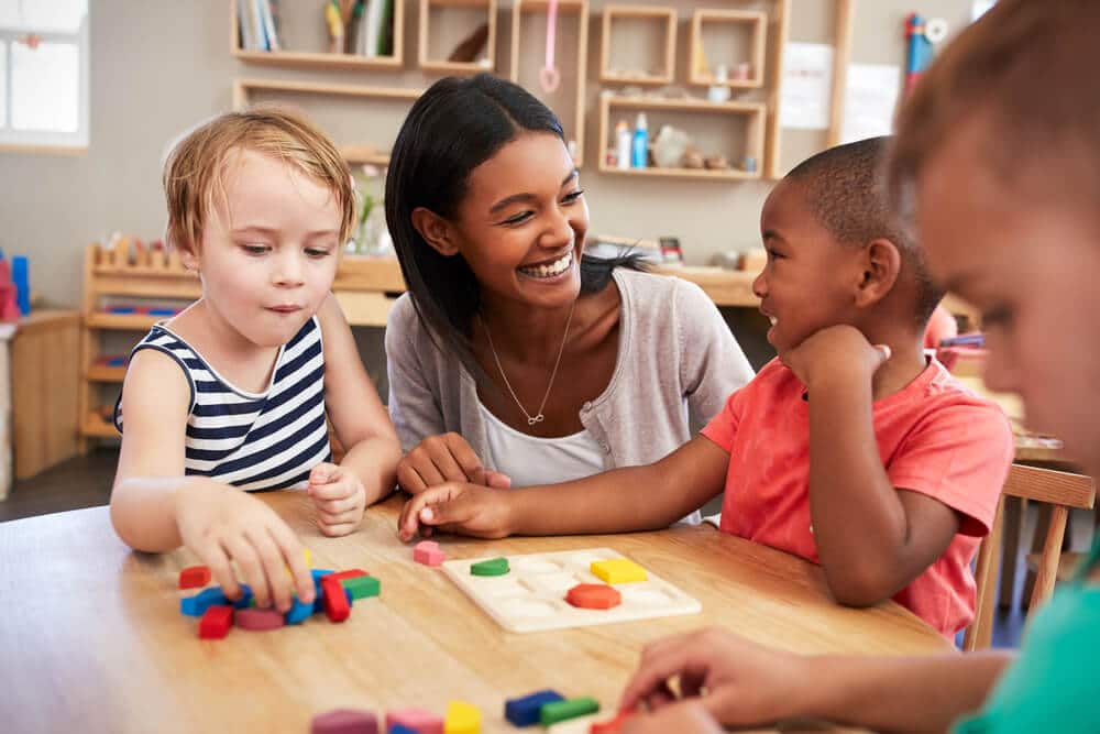 A teacher and children play