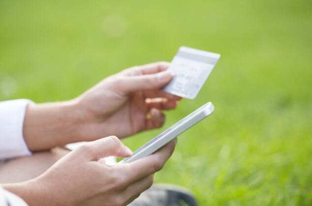Woman checking her CSL Plasma card balance using a smartphone