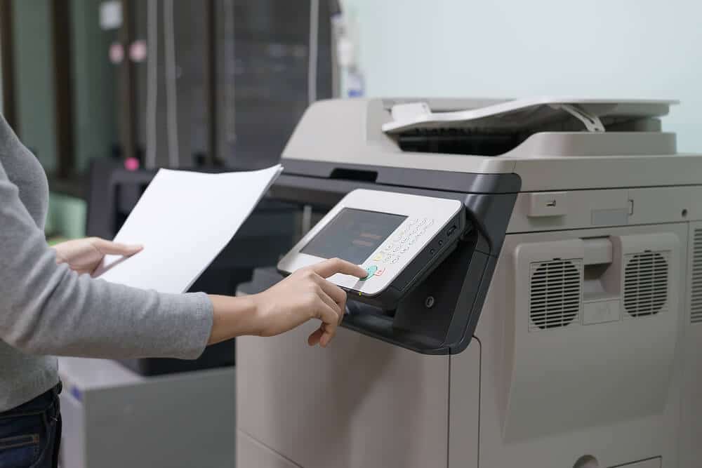 Woman using a printer to print documents and make copies