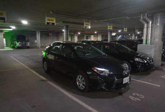 Rental cars parked in a dark parking garage after-hours