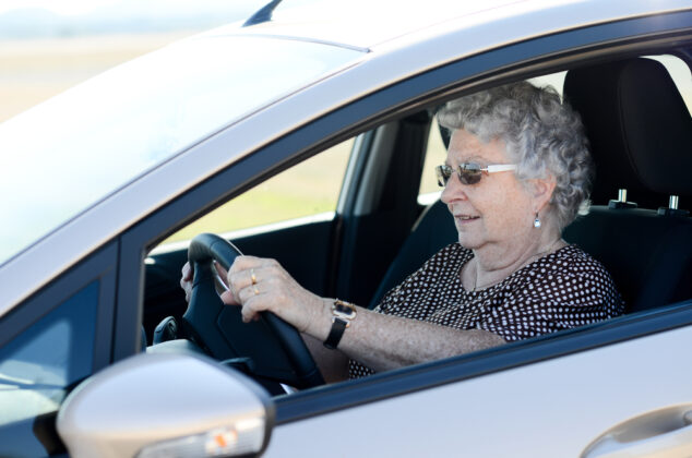 Elderly woman driving a rental car