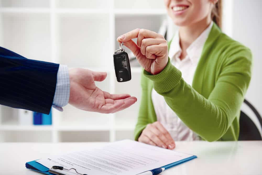 Car rental agent handing over keys