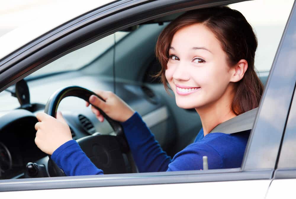Young woman driving a rental car