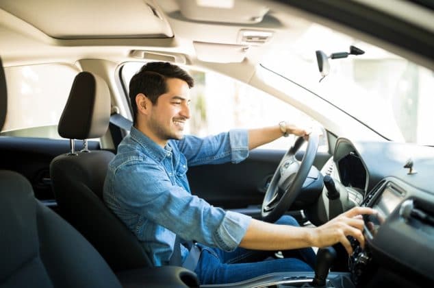 Man driving a rental car that accepts Chime credit cards