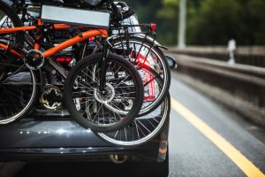 Close-up of the back of a car with a bike rack loaded with several bikes