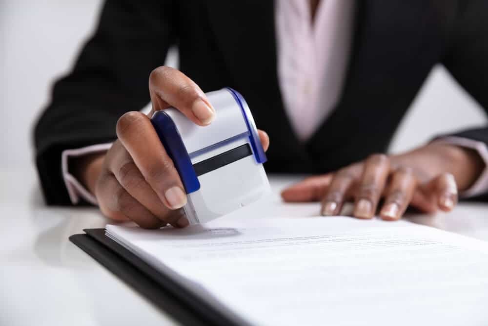 Bank employee putting a notary stamp on a document