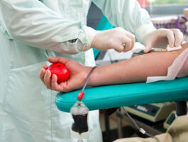 Nurse preparing a donor for a plasma donation