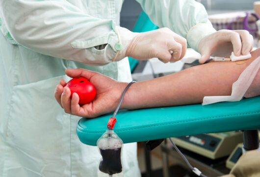 Nurse preparing a donor for a plasma donation