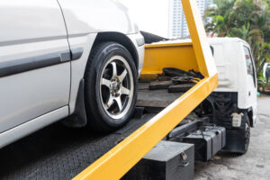 Car being loaded onto a tow truck during repossession
