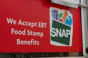 "We Accept EBT" sign on the door of a gas station
