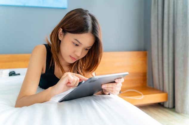 Young woman using a tablet in a hotel room