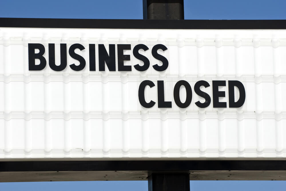 Black letters reading "Business Closed" appear on a white marquee sign