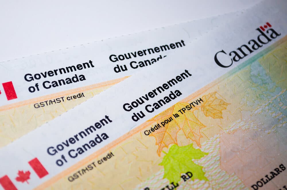 Two government-issued Canadian checks resting on a table