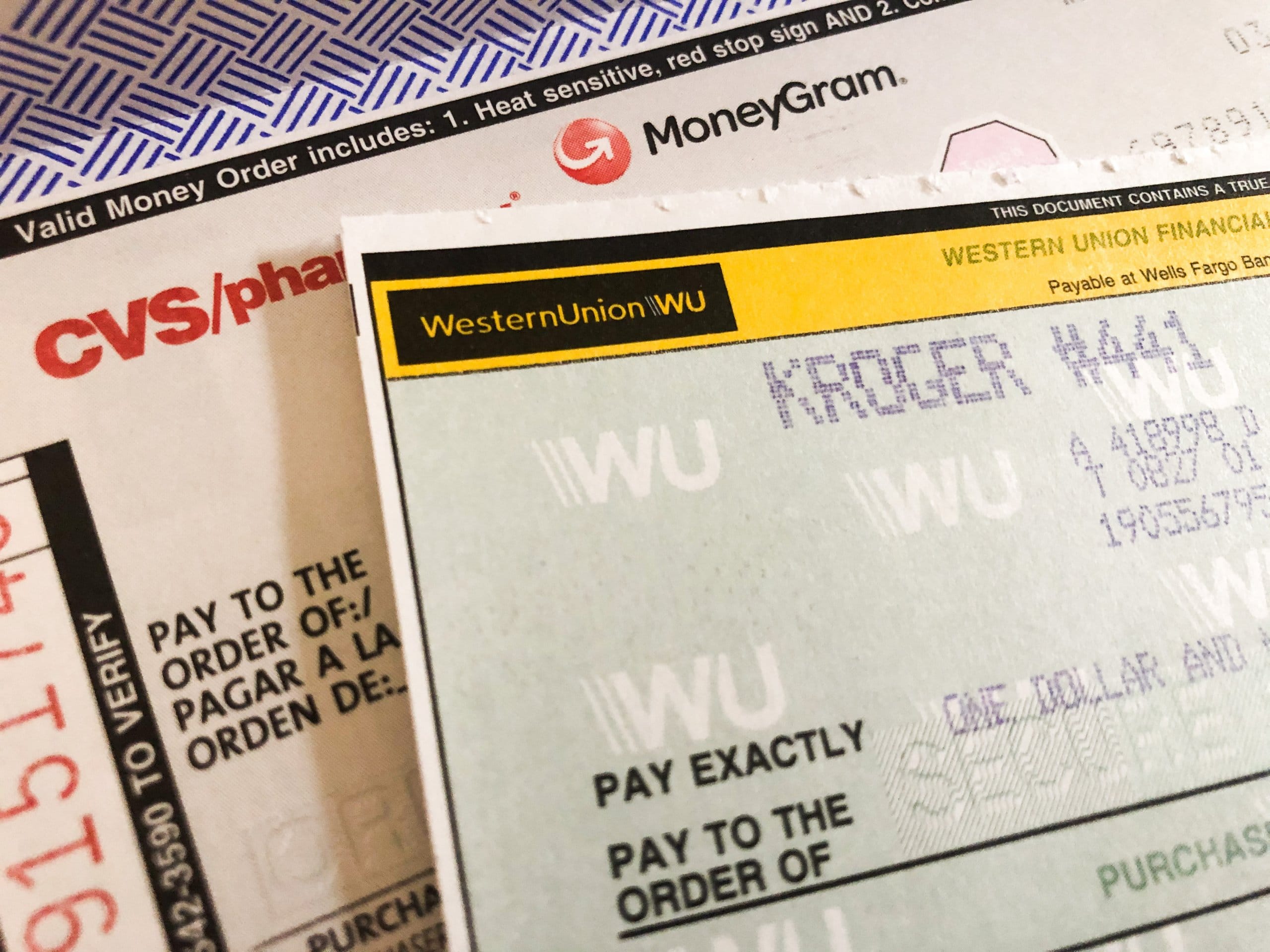 MoneyGram and Western Union money orders ready to fill out