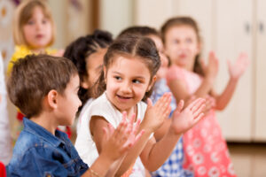 Children clapping at a preschool program like KLA Schools