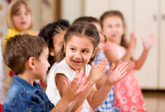 Children clapping at a preschool program like KLA Schools