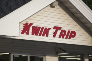Red Kwik Trip logo sign on the outside of a store