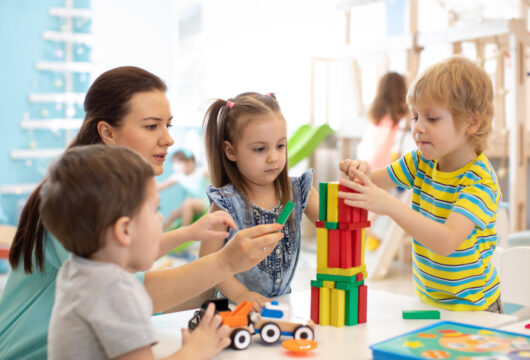 Children playing with blocks at a school like Little Sunshine's Playhouse and Preschool