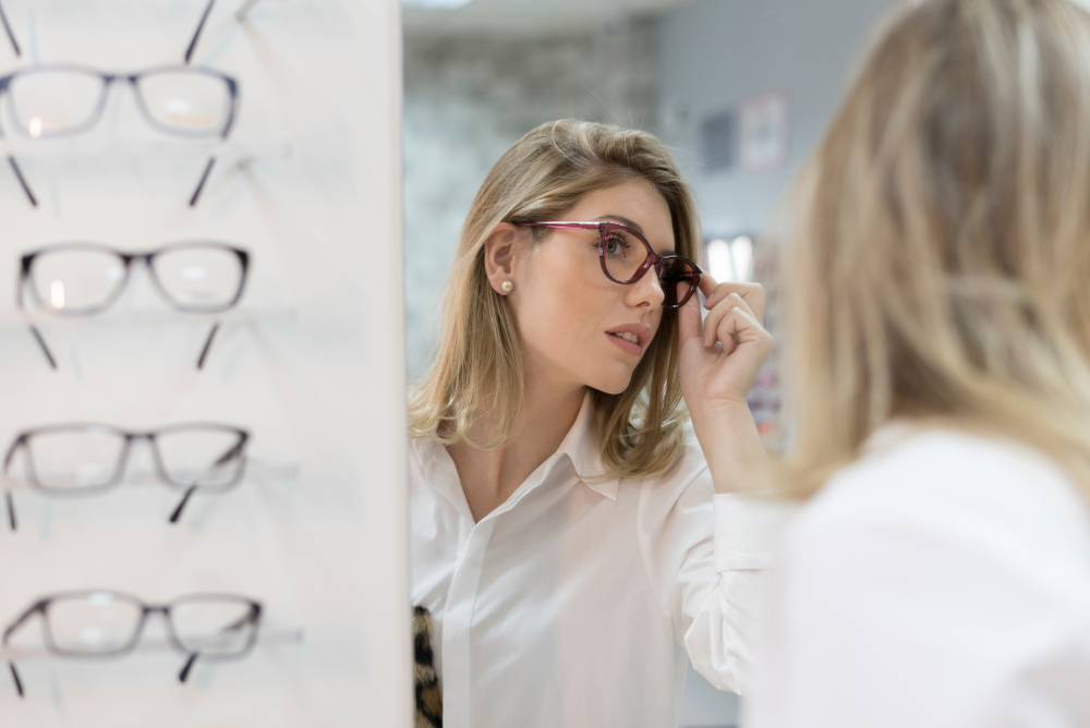 Woman trying on glasses at an optometry office