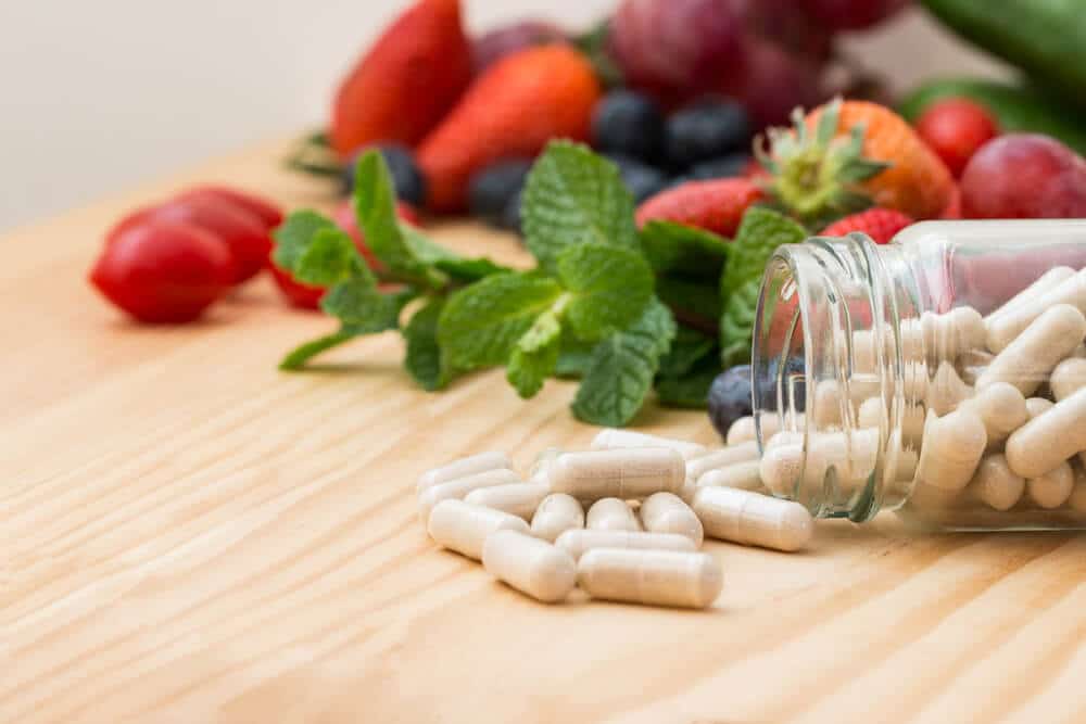 Capsules similar to Thrive on a table with fruits and vegetables