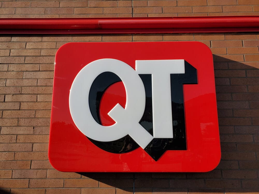 Red sign featuring QuikTrip's "QT" logo on the outside of the store