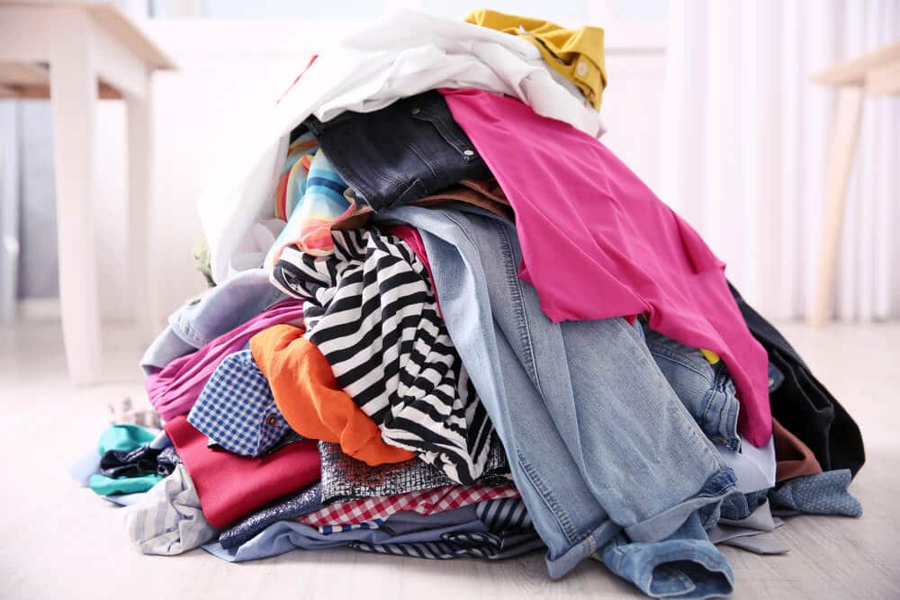 Pounds of clothing sitting in a pile on the floor