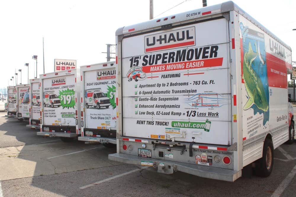 A row of parked U-Haul moving trucks