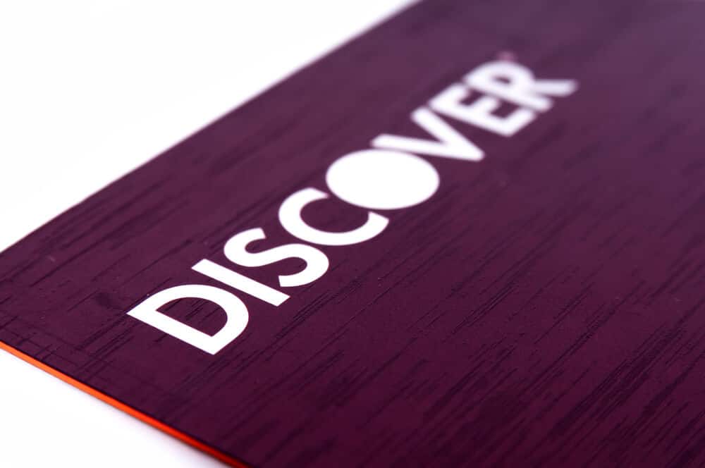 Close-up of the Discover logo on the top left corner of a credit card