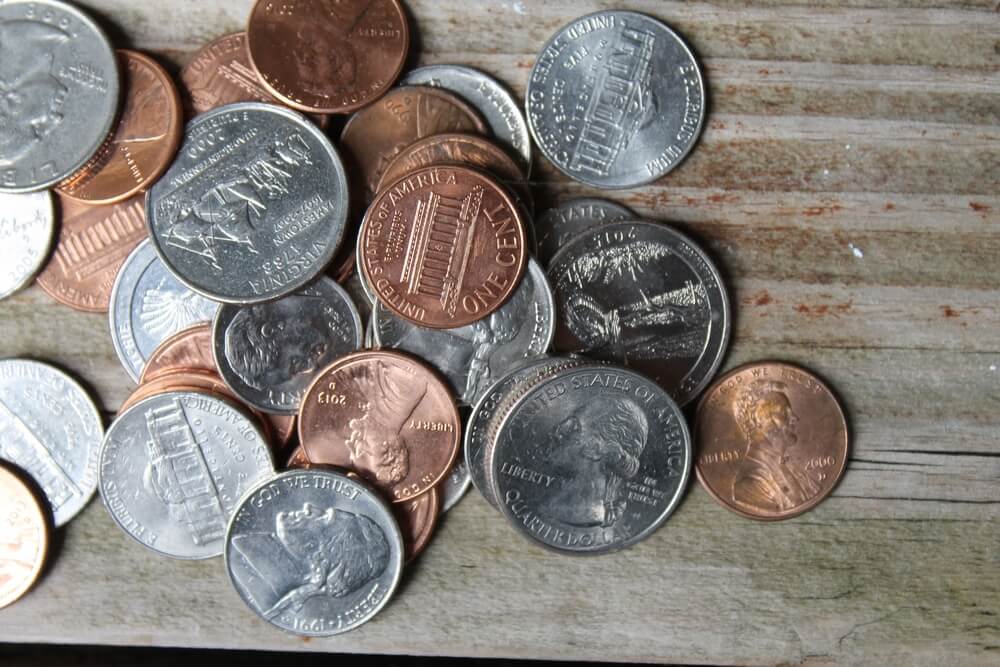 a pile of loose coins on a table